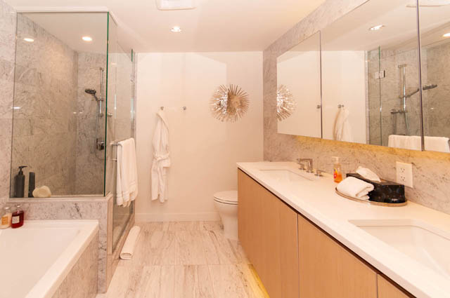 Spacious penthouse bathroom with marble countertops, wooden flooring, and a modern shower. - 2818  - 89 Nelson Street, Vancouver Downtown