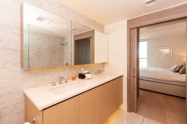 Spacious bathroom with marble countertops and wooden cabinetry, offering a modern and luxurious feel. - 2818  - 89 Nelson Street, Vancouver Downtown