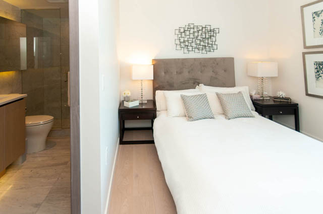 Spacious bedroom with hardwood floors, modern decor, and a view of the city. - 2818  - 89 Nelson Street, Vancouver Downtown