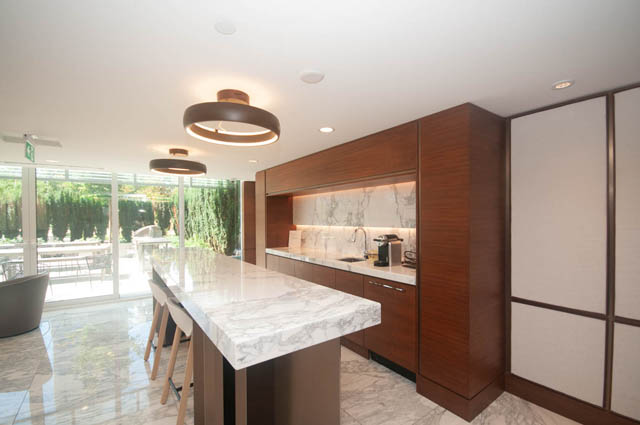 Modern kitchen with marble countertops and sleek wood cabinetry. - 2818  - 89 Nelson Street, Vancouver Downtown