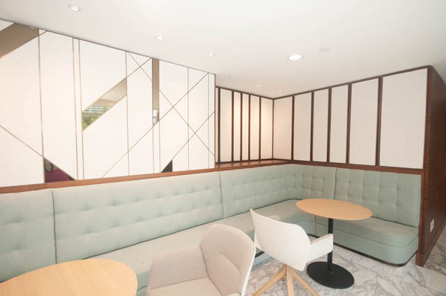 Spacious lounge with modern furniture, geometric wall panels, and cozy cushioned seating. - 2818  - 89 Nelson Street, Vancouver Downtown