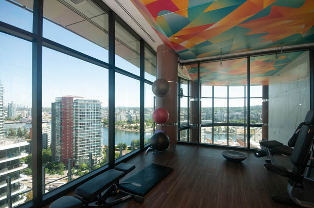 Spacious penthouse gym with hardwood floors, city view, and vibrant ceiling design. - 2818  - 89 Nelson Street, Vancouver Downtown