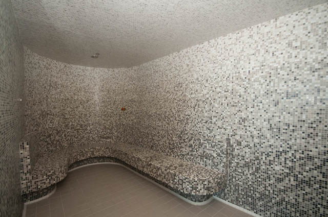 Spacious penthouse bathroom with mosaic tile walls and built-in bench seating. - 2818  - 89 Nelson Street, Vancouver Downtown