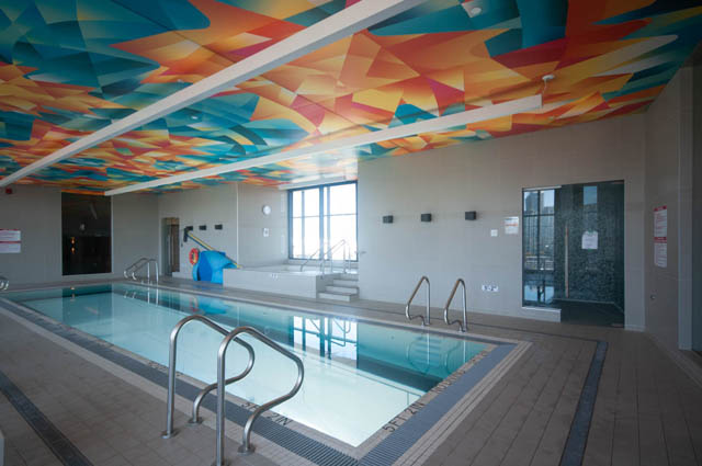 Spacious penthouse with vibrant, geometric ceiling and modern, tiled pool area. - 2818  - 89 Nelson Street, Vancouver Downtown