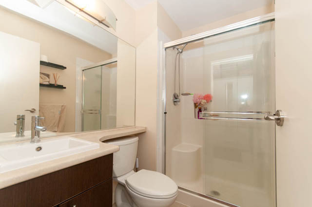 Spacious bathroom with a large vanity and a walk-in shower. - 102-1633 Mackay Avenue, North Vancouver
