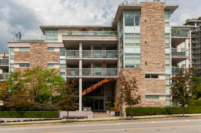 Spacious 1-bedroom condo with large balcony, modern stone facade, and city views. - 105 - 210 West 13th Street, North Vancouver