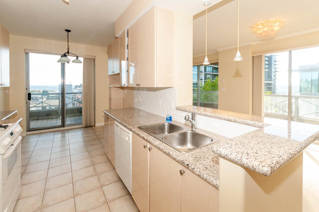 Bright kitchen with granite countertops and city views from large windows. - 607-160 E 13th Street, North Vancouver
