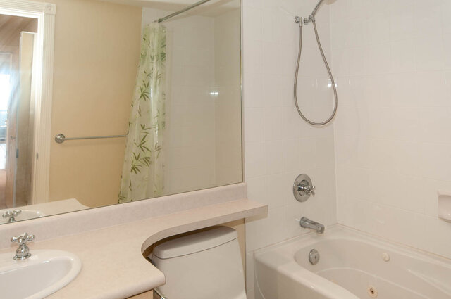 Bathroom with light countertop and tiled shower walls. - 607-160 E 13th Street, North Vancouver