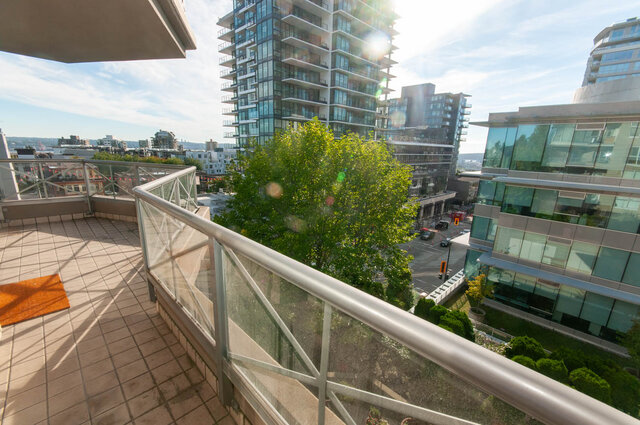 Balcony with glass railings and city view. - 607-160 E 13th Street, North Vancouver