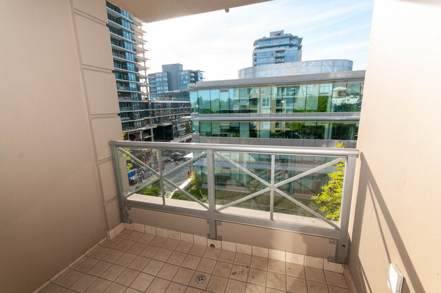 Balcony with tiled floor and city view of modern high-rises. - 607-160 E 13th Street, North Vancouver