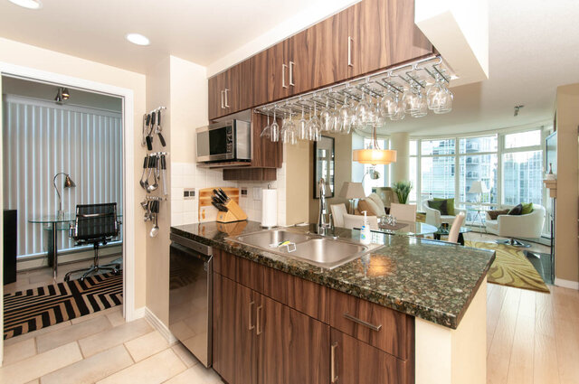 Bright kitchen with granite countertops, hardwood floors, and a city view. - 905 - 1199 Marinaside Cres., Vancouver Downtown