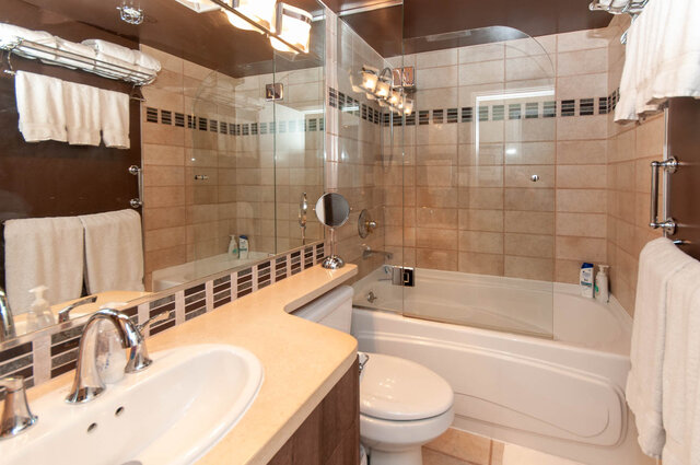 Spacious bathroom with dual sinks, large mirror, and walk-in shower. - 905 - 1199 Marinaside Cres., Vancouver Downtown