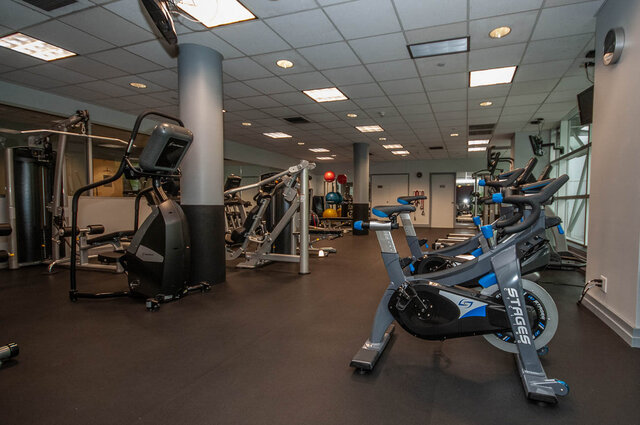 Spacious, well-equipped gym with cardio machines and weights, ideal for fitness enthusiasts. - 905 - 1199 Marinaside Cres., Vancouver Downtown