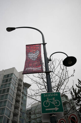 Furnished 1-bedroom + den condo with a bike-friendly sign and Yaletown banner, located in Vancouver Downtown.