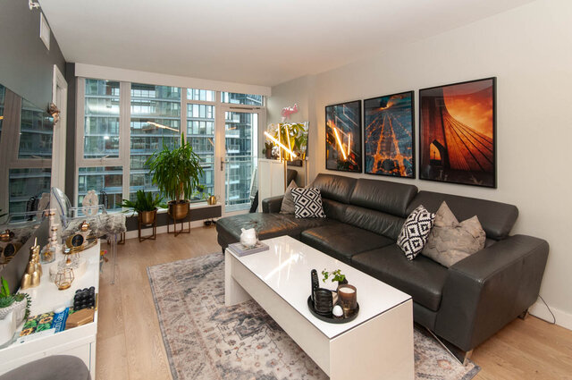 Spacious living room with hardwood floors, modern leather sectional, city view, and stylish decor. - 1006 -1618 Quebec Street, Vancouver East Side