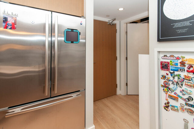 Bright kitchen with stainless steel appliances, hardwood floors, and a cozy den area. - 1006 -1618 Quebec Street, Vancouver East Side