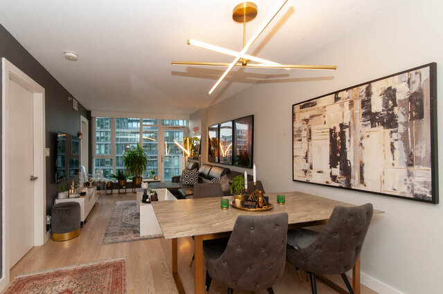 Modern dining area with large abstract art, hardwood floors, and city view. - 1006 -1618 Quebec Street, Vancouver East Side