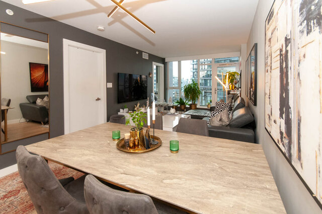 Spacious dining area with marble table, modern decor, and city view. - 1006 -1618 Quebec Street, Vancouver East Side