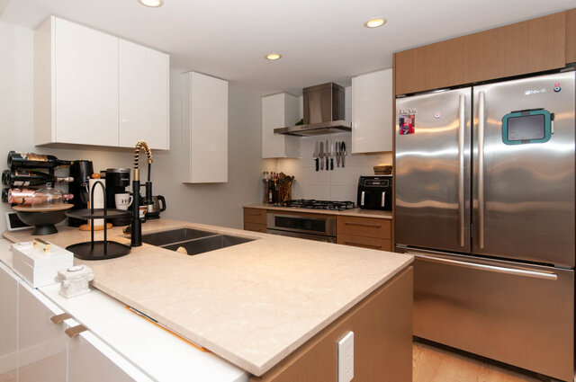 Modern kitchen with granite countertops, stainless steel appliances, and a large island. - 1006 -1618 Quebec Street, Vancouver East Side