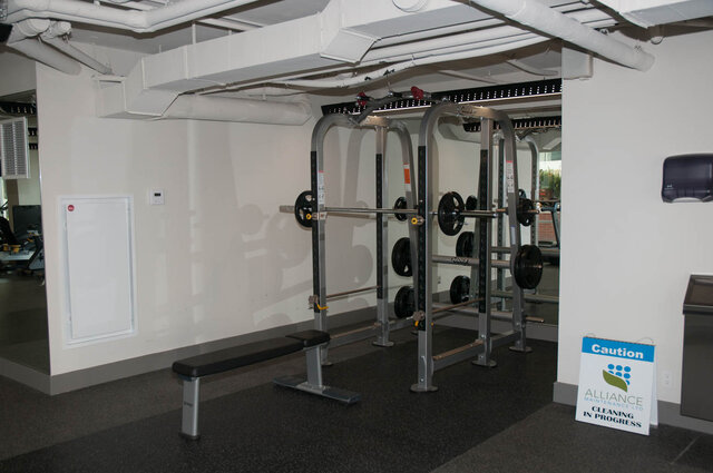 Spacious gym with weightlifting equipment and industrial-style ceiling. - 1006 -1618 Quebec Street, Vancouver East Side