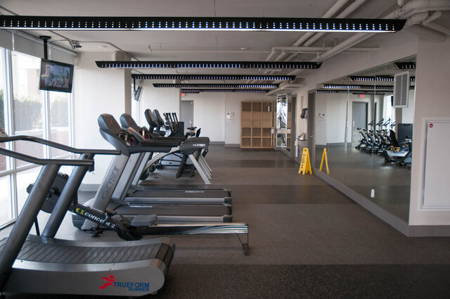 Spacious gym with treadmills, mirrors, and LED lights, perfect for fitness enthusiasts. - 1006 -1618 Quebec Street, Vancouver East Side