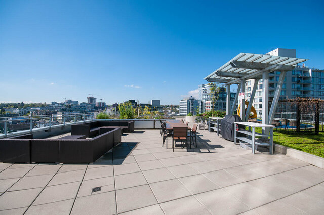 Spacious rooftop patio with city views, modern furniture, and a covered grill area. - 1006 -1618 Quebec Street, Vancouver East Side