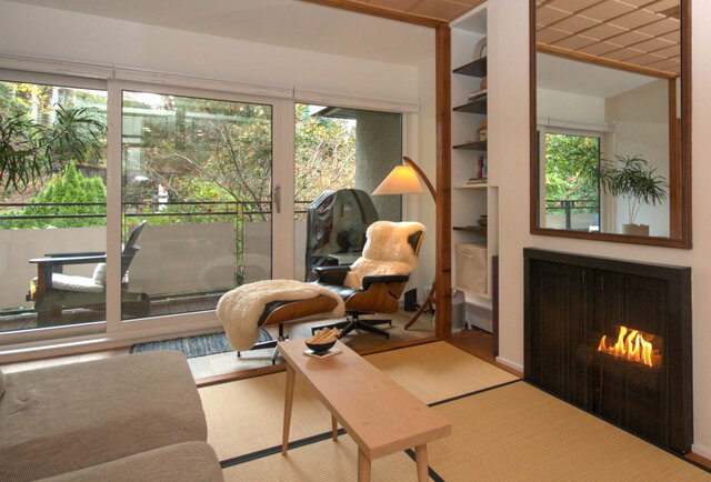 Spacious living room with sliding glass doors, cozy seating, and a modern fireplace. - 507 - 1405 West 15th Ave, Vancouver West Side