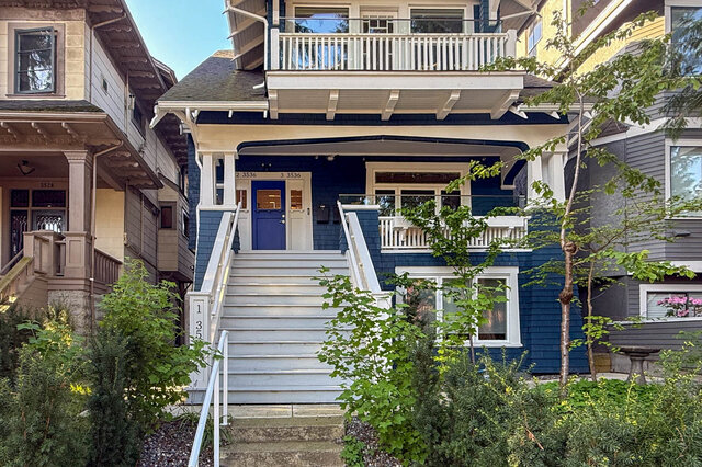 Spacious 2-bedroom furnished apartment with a charming blue exterior and white railings, perfect for a cozy stay in...