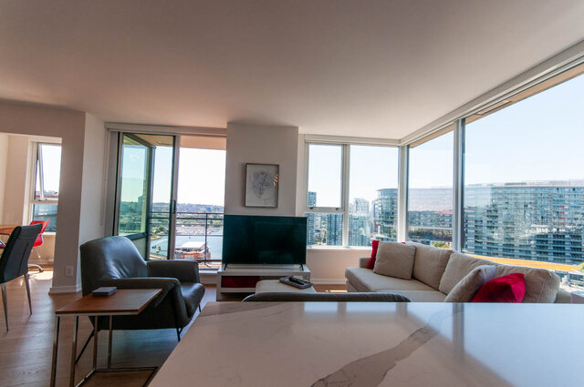 Spacious living room with a marble countertop and stunning city view. - 3006 - 33 Smithe Street, Vancouver Downtown