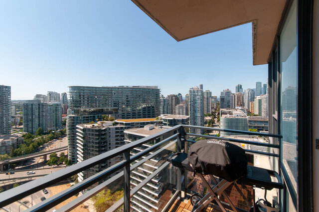 Furnished balcony with stunning city view and modern furnishings. - 3006 - 33 Smithe Street, Vancouver Downtown