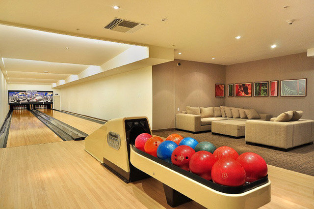 Spacious living room with bowling alley, colorful bowling balls, and modern furniture. - 3006 - 33 Smithe Street, Vancouver Downtown