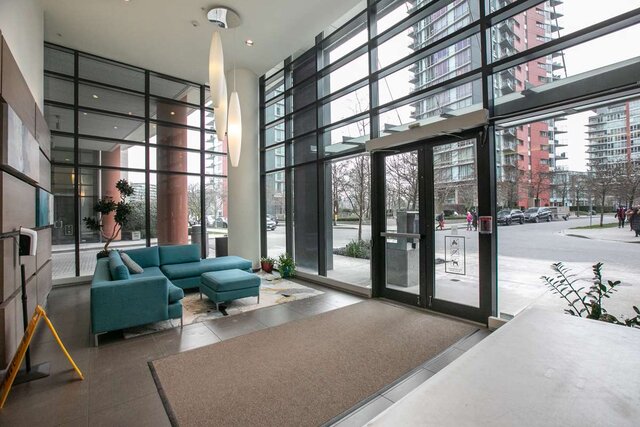 Spacious living room with modern furnishings and large windows offering a city view. - 3006 - 33 Smithe Street, Vancouver Downtown
