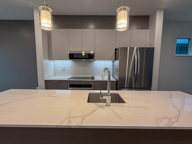 Bright modern kitchen with white marble countertops and stainless steel sink. - TH 12 - 2030 East 20th Ave, Vancouver East Side