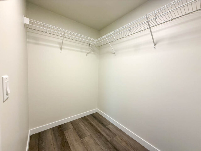 Closet with white wire shelving and dark hardwood flooring. - TH 12 - 2030 East 20th Ave, Vancouver East Side