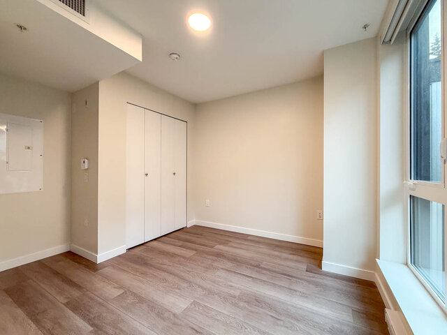 Spacious bedroom with hardwood floors and ample closet space. - TH 13 - 2030 East 20th Ave, Vancouver East Side