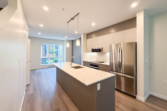 Modern kitchen with white marble countertops, stainless steel appliances, and hardwood floors. - TH 46- 2050 East 20th Ave, Vancouver East Side