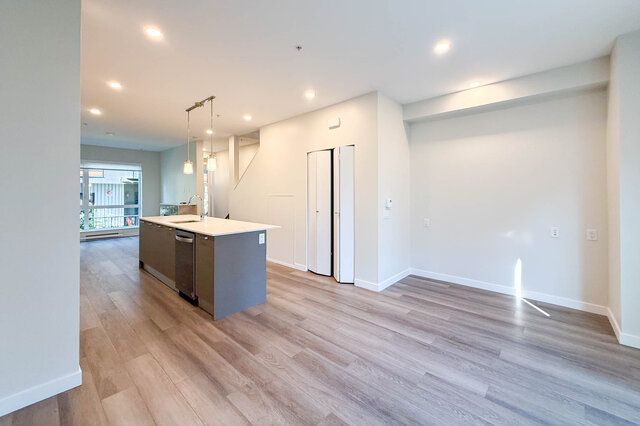 Open-concept living space with hardwood floors and modern kitchen island. - TH 46- 2050 East 20th Ave, Vancouver East Side