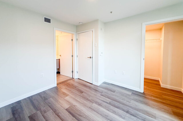Spacious bedroom with hardwood floors and a walk-in closet. - TH 46- 2050 East 20th Ave, Vancouver East Side