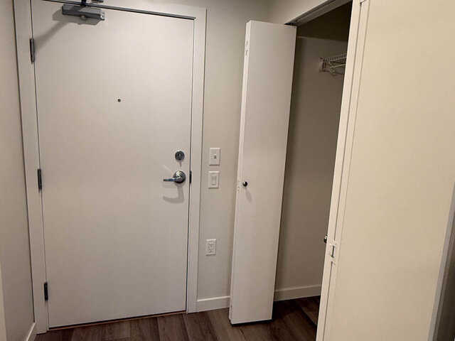 Entry with the front door and an open coat closet beside it - 302-3588 Hull St, Vancouver East Side