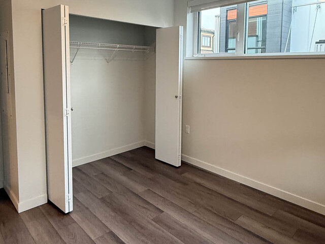 Bedroom with a wide bifold closet and a window - 302-3588 Hull St, Vancouver East Side