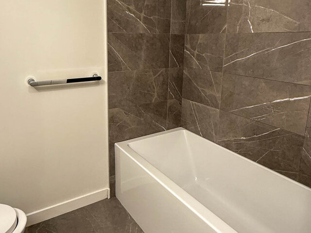 Bathtub set against grey veined wall tile - 302-3588 Hull St, Vancouver East Side