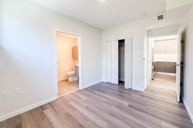 Closet with white wire shelving and light hardwood flooring. - 400 - 3588 Hull St, Vancouver East Side