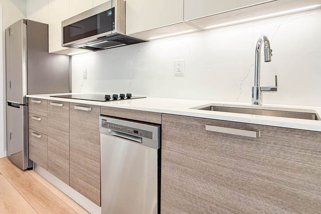 Bright kitchen with light wood cabinets, white countertops, and stainless steel appliances. - G 22 - 2070 East 20th Ave, Vancouver East Side