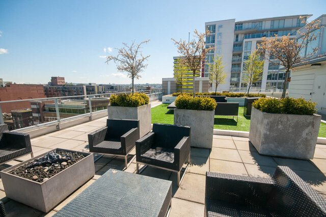 The balcony features outdoor seating, concrete planters with greenery, artificial turf, and a city view. - 812-189 Keefer Street, Vancouver Downtown
