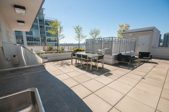 The balcony features an outdoor dining set, potted trees, and a city view. - 812-189 Keefer Street, Vancouver Downtown