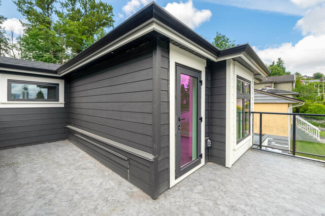 Modern 3-bedroom + den duplex with sleek gray siding and vibrant purple accents. - 1-4096 Nithsdale Street, Burnaby