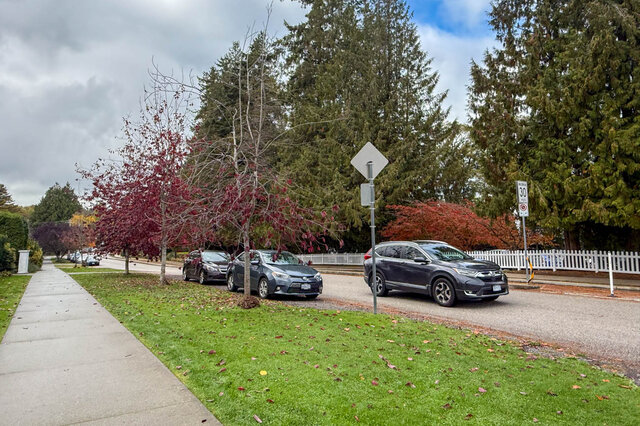 Furnished living room with cozy corner fireplace and large windows. - 3850 Point Grey Road, Vancouver West Side