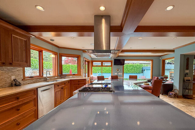 Open-concept kitchen and dining area with modern countertops and large windows. - 3850 Point Grey Road, Vancouver West Side