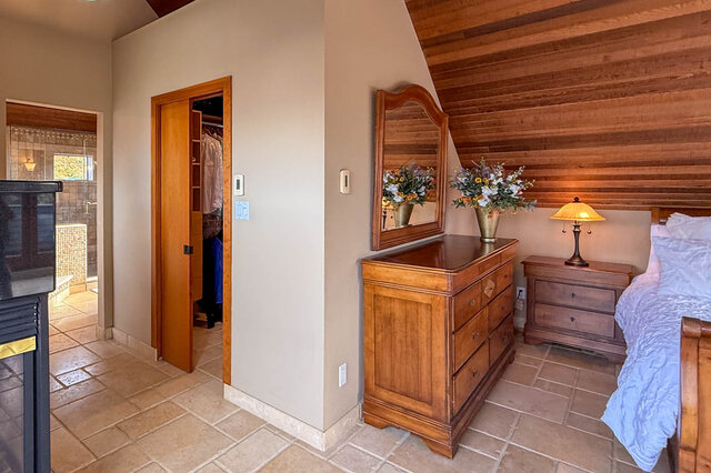 Spacious bedroom with wooden ceiling, dresser, and cozy bed, perfect for relaxation. - 3850 Point Grey Road, Vancouver West Side