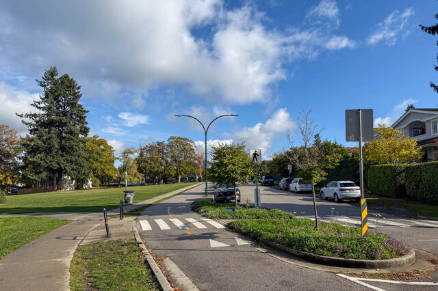 Spacious living room with a sunny, tree-lined street view and a modern, well-maintained exterior. - 3850 Point Grey Road, Vancouver West Side